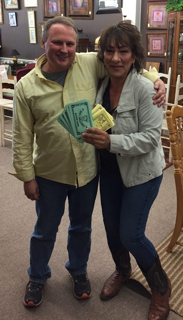 Taking top prize of $250 in North Webster Christmas Cash is Janine Palm, right. She entered at Tangibles Resale & Consignment and is shown with store owner Scott Kuhn. Christmas Cash can be spent by the winners at any participating merchant.