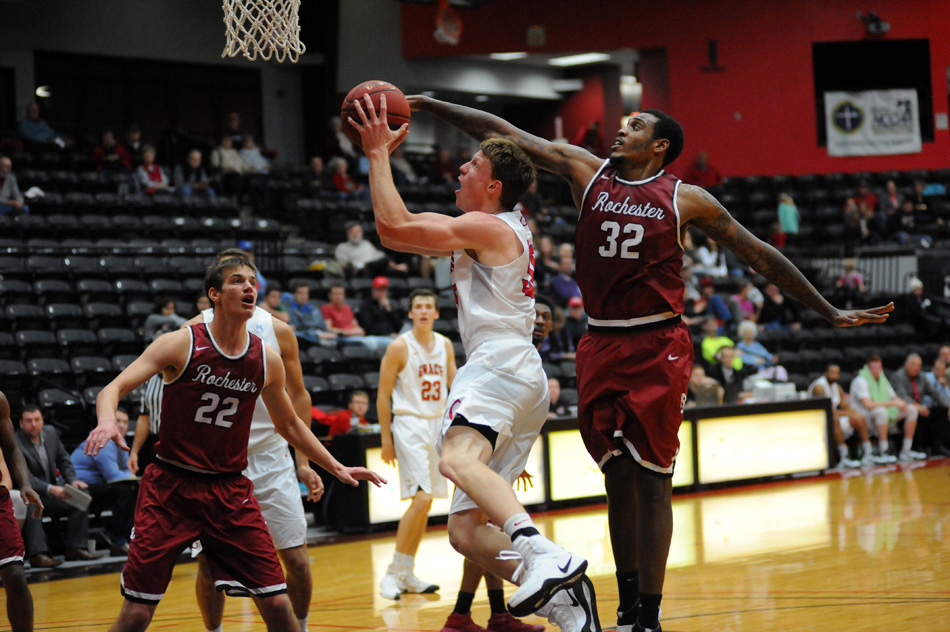 Grace's Erik Bowen drives in for a bucket against Rochester Saturday night. (Photos by Mike Deak)