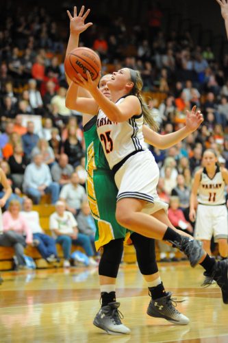 Warsaw's Madi Graham goes in for two against Anne Secrest.