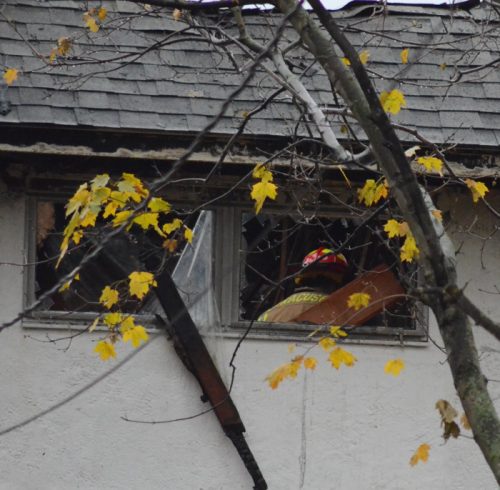 A firefighter in the upstairs area of the residence after being called back to the home Friday morning.