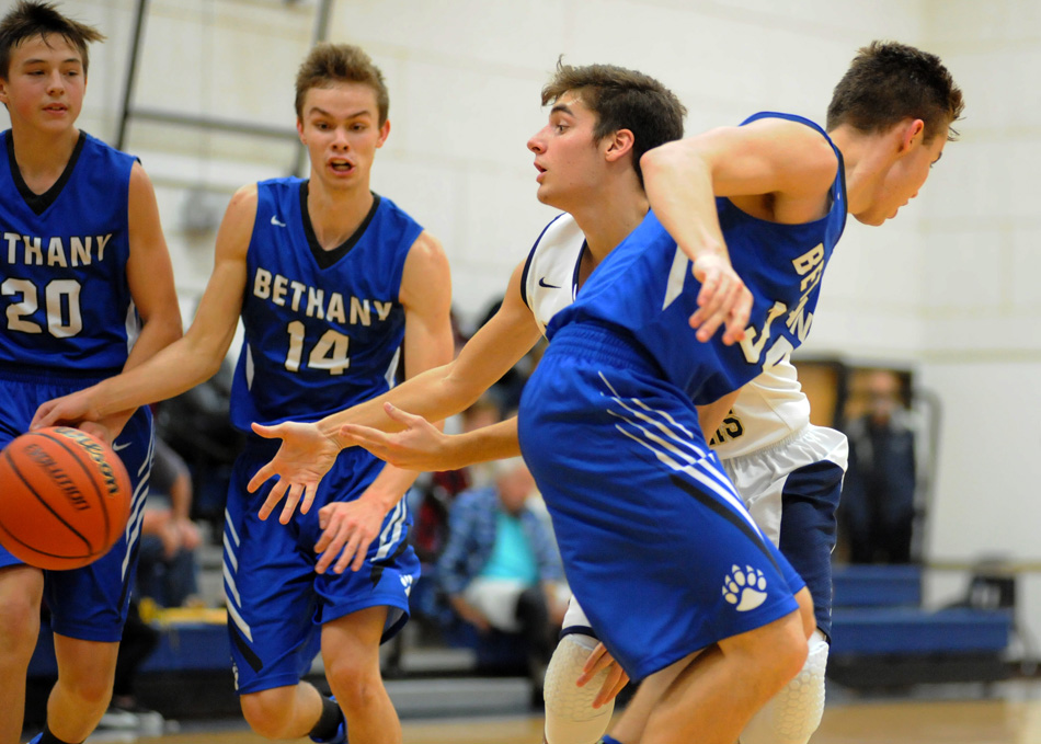 Lakeland Christian Academy's Landon Twombly whistles a pass between three Bethany Christian defenders Tuesday night in a 52-40 BC win over LCA. (Photos by Mike Deak)
