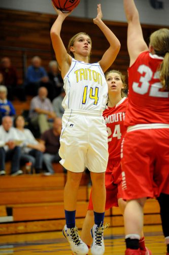 Triton's Whytnie Miller put up a shot attempt over Plymouth's Cece Robinson.