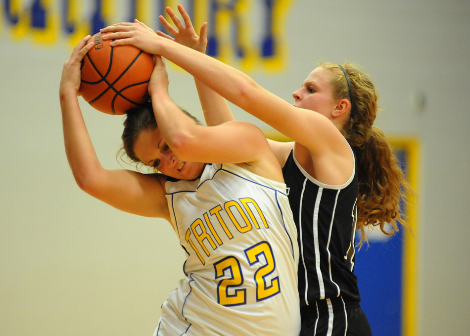 Triton's Nicole Sechrist is hounded by John Glenn's Mariah Plunkett.