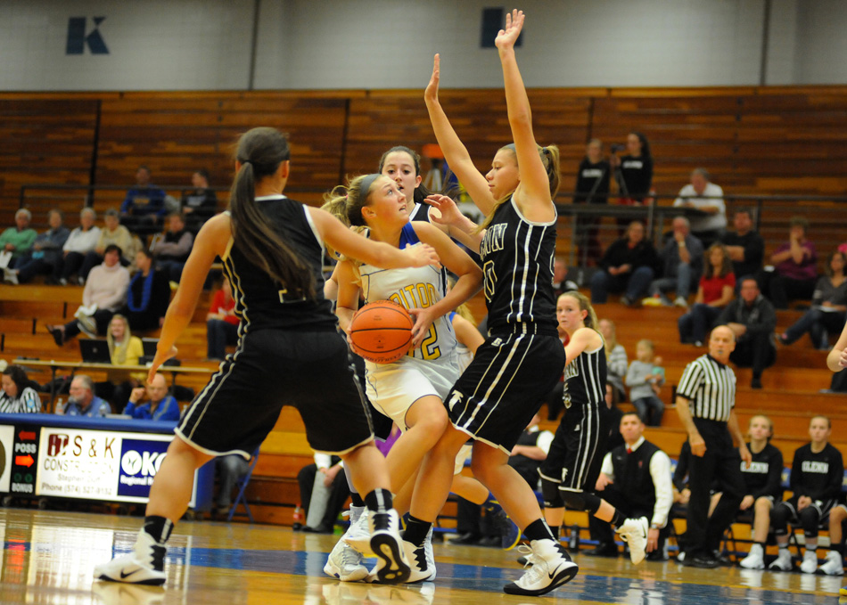 John Glenn collapses on Triton's Hannah Wanemacher in a 70-41 Falcons rout Friday night. (Photos by Mike Deak)