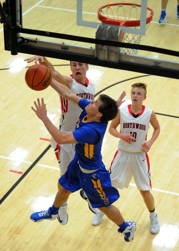 NorthWood's Trey Bilinski blocks Nathan Flenar's shot Friday night in the Panther's 59-43 win over Triton. (Photos by Mike Deak)