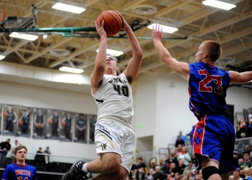 Trevon Coleman of Wawasee rises for a shot over Whitko's Nate Walpole.