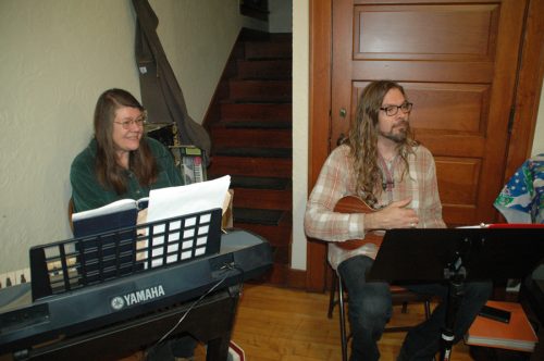 Christina Archer, left, organized the Candaleria and Mike Beezley played ukelele to accompany Christmas carols.