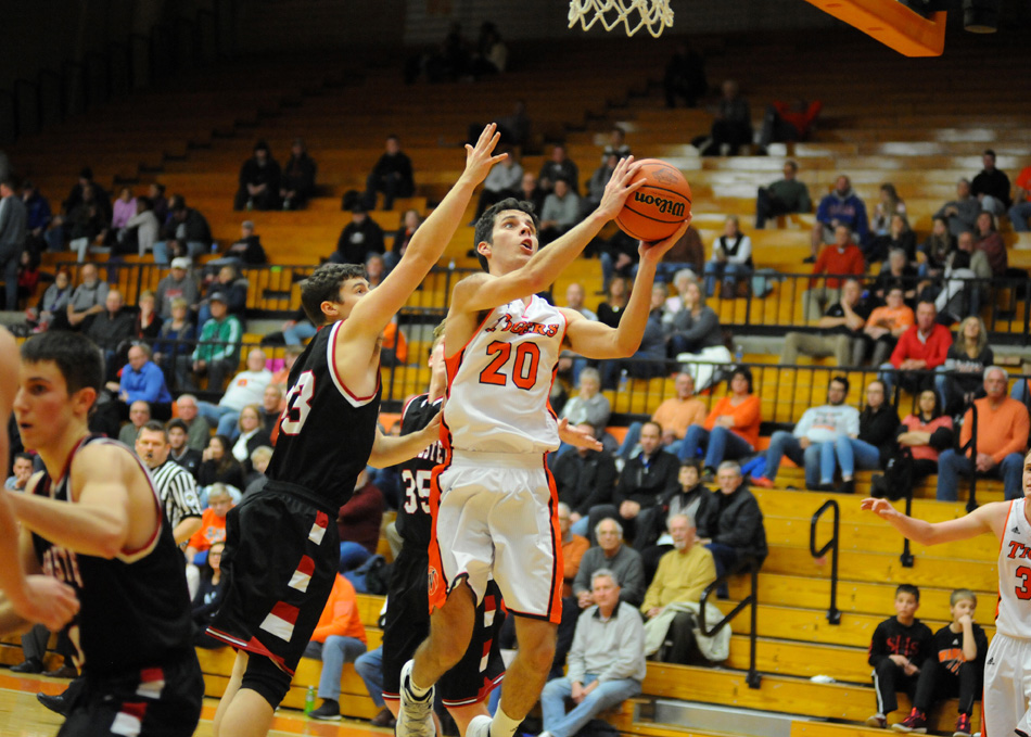 Warsaw's Ross Johnson drives in for a layup against Manchester.