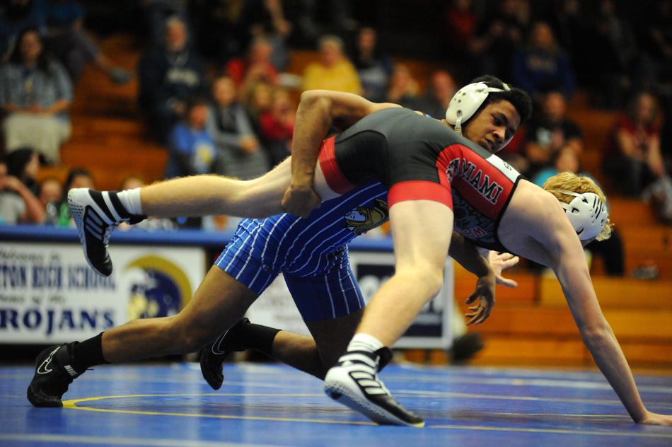 Triton's Marcus Brown tries to gain leverage on North Miami's Austin Fletcher.