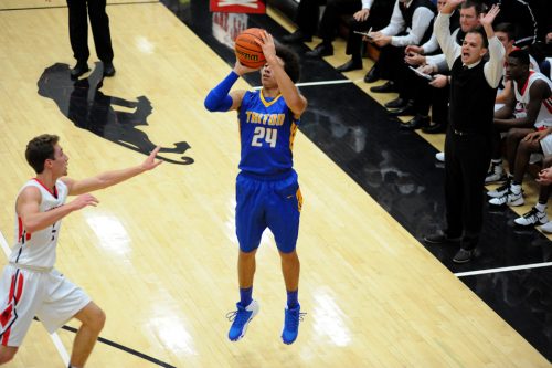 Triton's Zac Pitney takes a three-point shot at NorthWood.