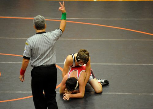 Warsaw's Riley Hogenson scores a takedown on Plymouth's Jordan Howard.