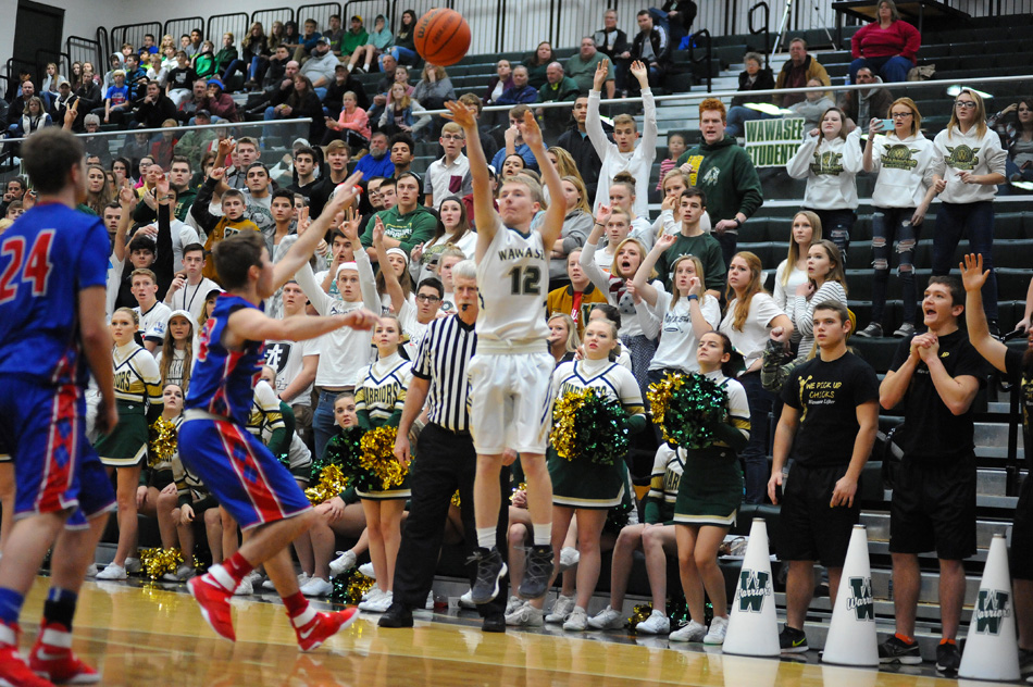 Wawasee's fan base waits in anticipation as Cameron Schlabach fires away what would be a tying three-pointer in what became a 54-47 Wawasee win over Whitko in a double-overtime thriller. (Photos by Mike Deak)